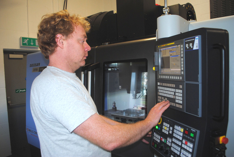 Mills CNC's Matt North working on machinery