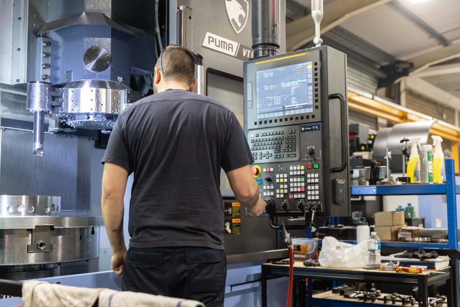 Operator working the controls of a VT900 vertical turning lathe