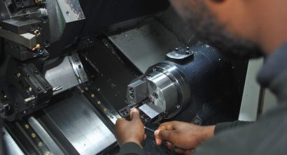 Close up of an operator at the interior of a Doosan Lynx 2100LSYA Horizontal Single Turret Lathe