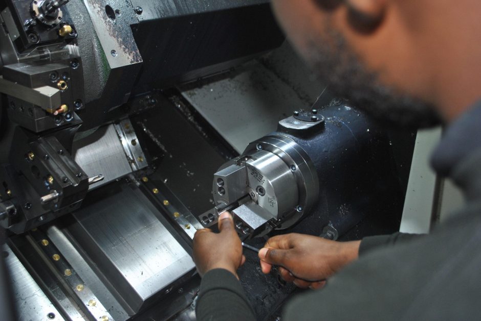 Close up of an operator at the interior of a Doosan Lynx 2100LSYA Horizontal Single Turret Lathe